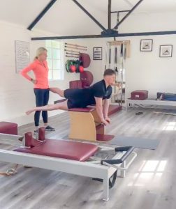 Man on Wunda chair Pilates apparatus in spinal extension